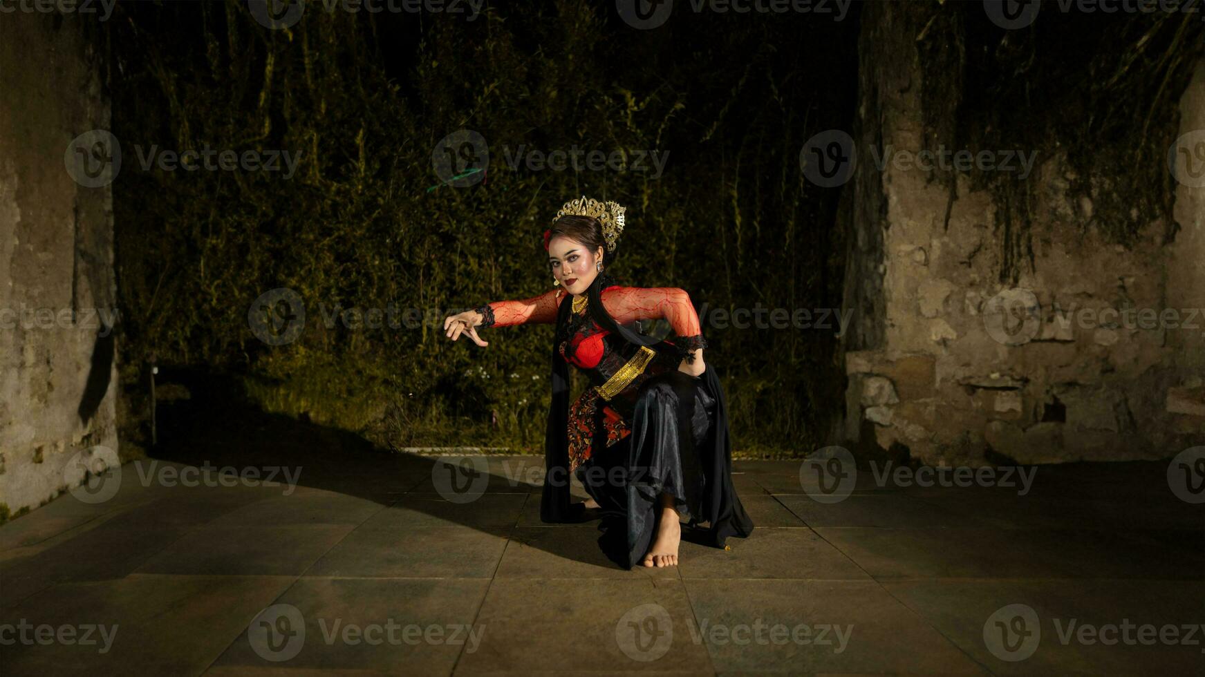 a Javanese dancer makes flexible and flowing movements in time with the rhythm of the music photo