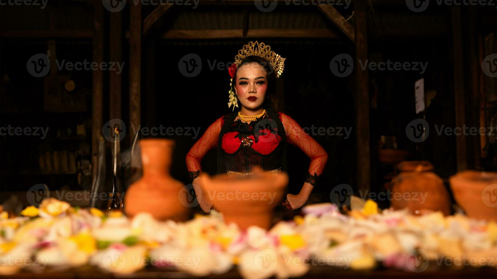 a female dancer sits gracefully and begins her ritual in front of beautiful offerings photo