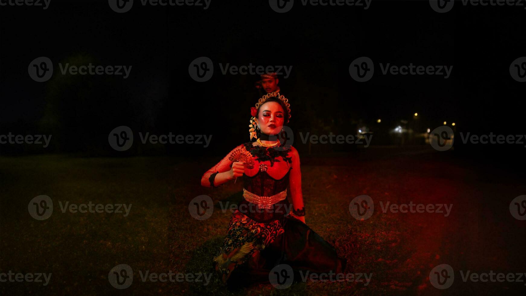 a group of female dancers with faces full of sadness sitting alone in the middle of a field photo