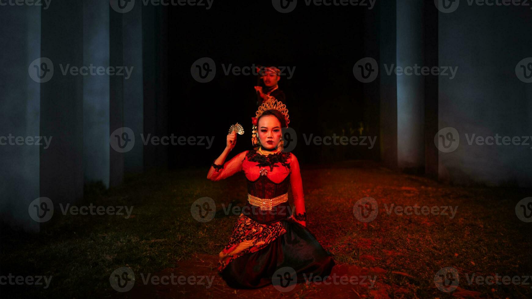 a female dancer in a red costume sat in the silence of the night which strengthened the sadness photo