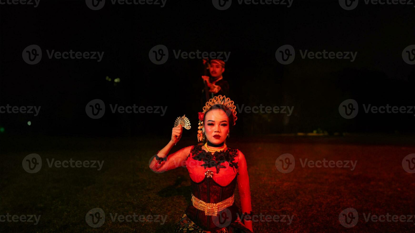a group of female dancers with faces full of heavy emotional burdens sitting in the dark of night photo