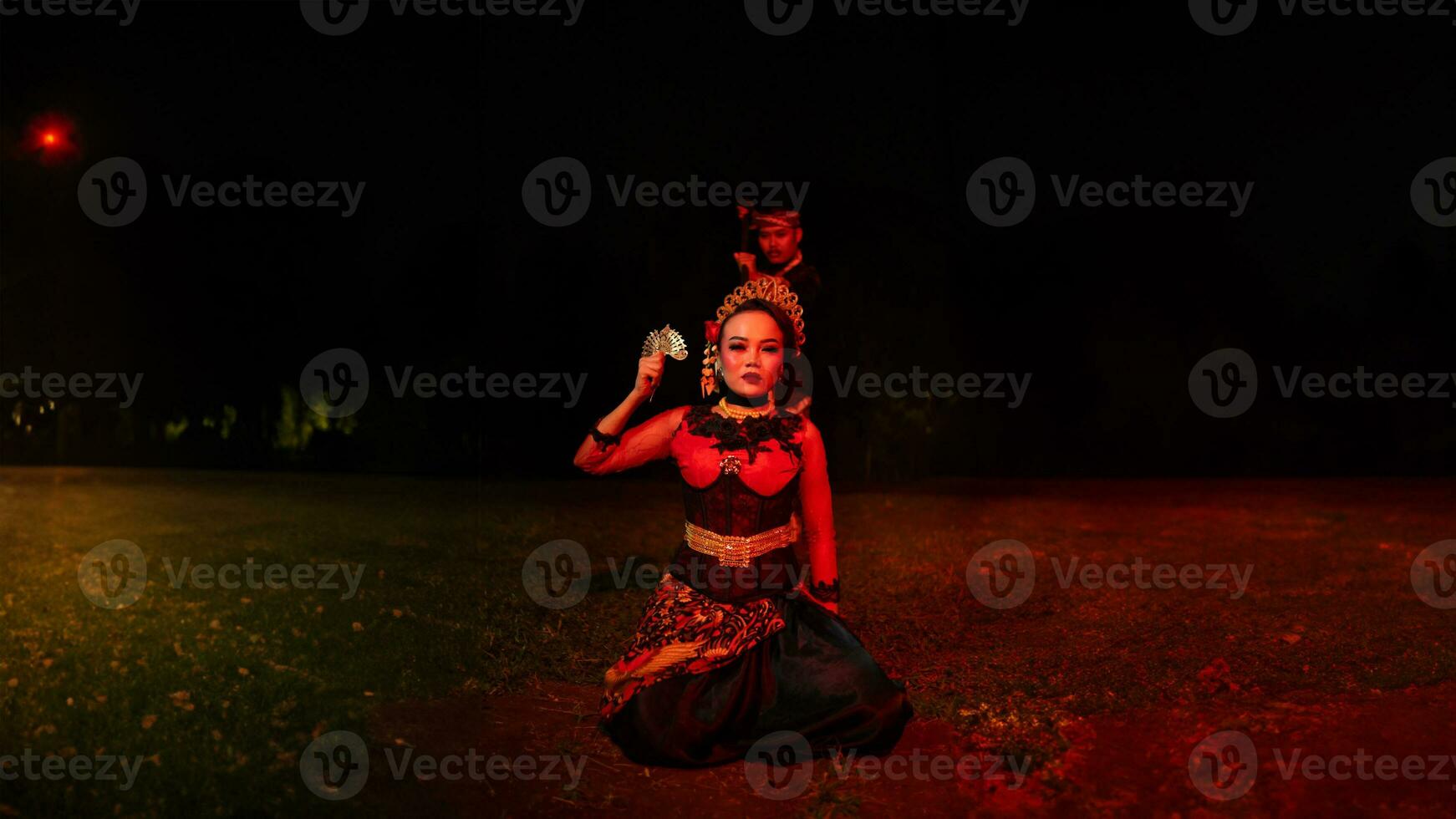 a group of female dancers with faces full of heavy emotional burdens sitting in the dark of night photo