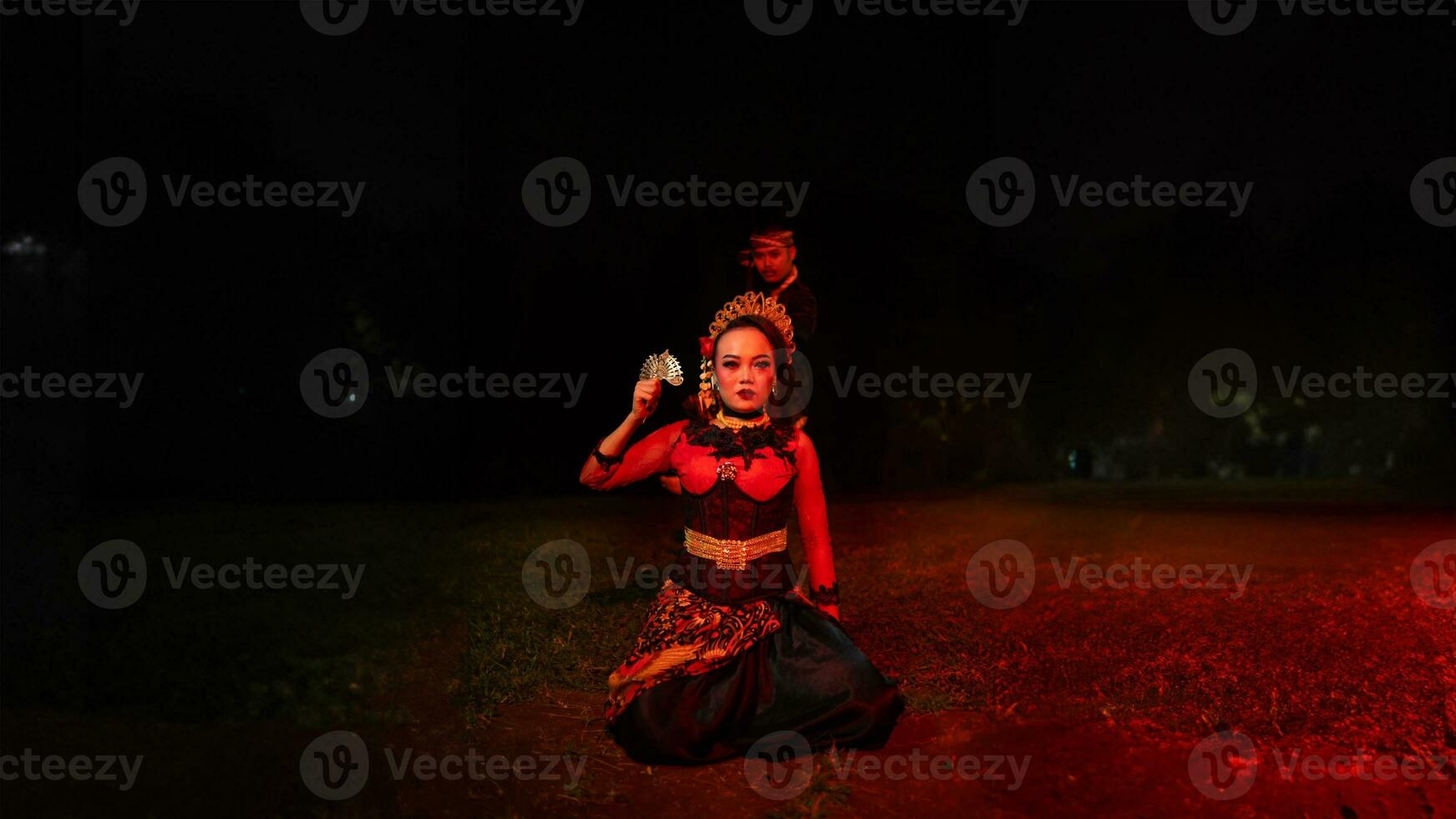 a group of female dancers with faces full of sadness sitting alone in the middle of a field photo