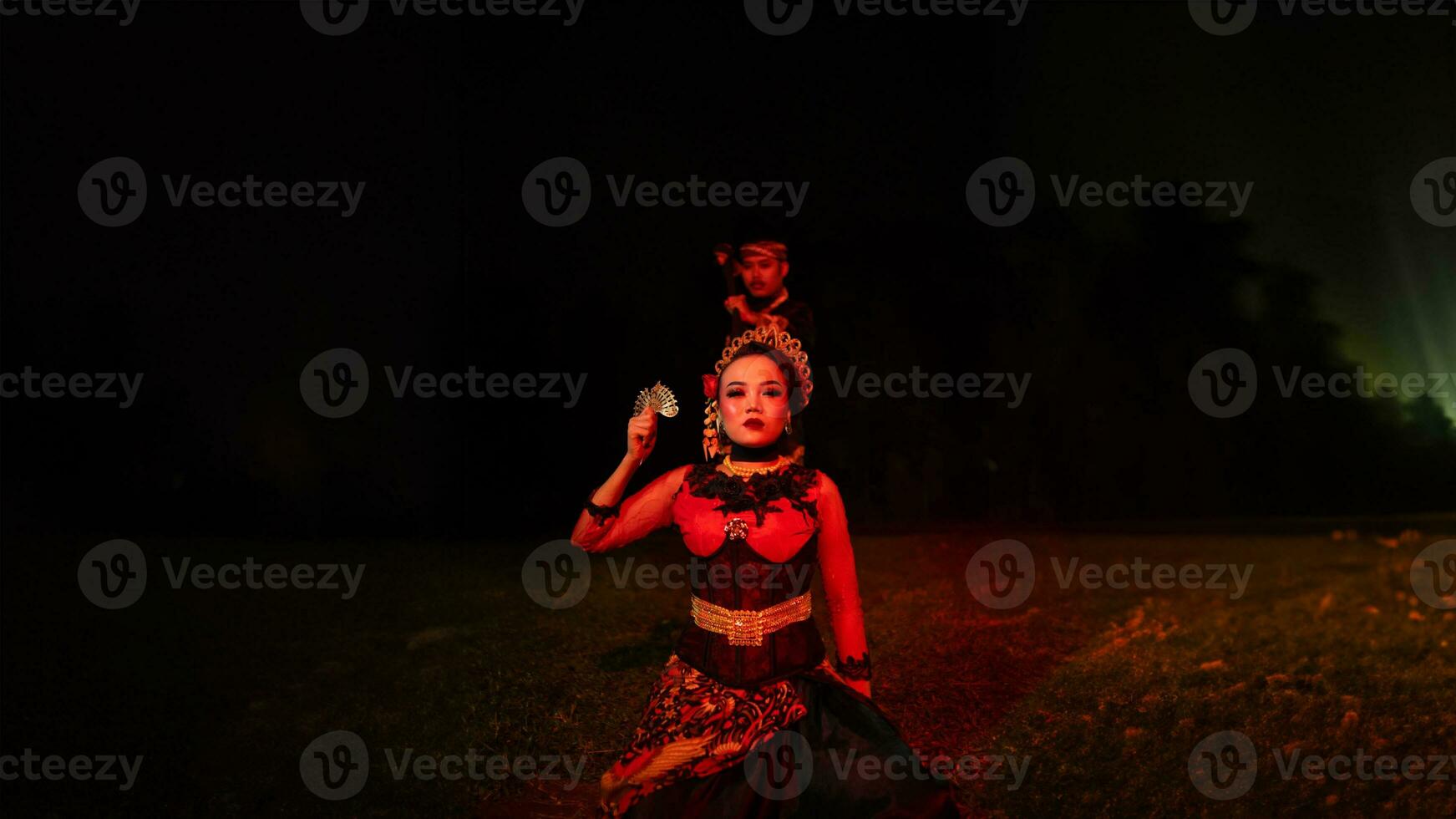 a female dancer in a red costume sat in the silence of the night which strengthened the sadness photo