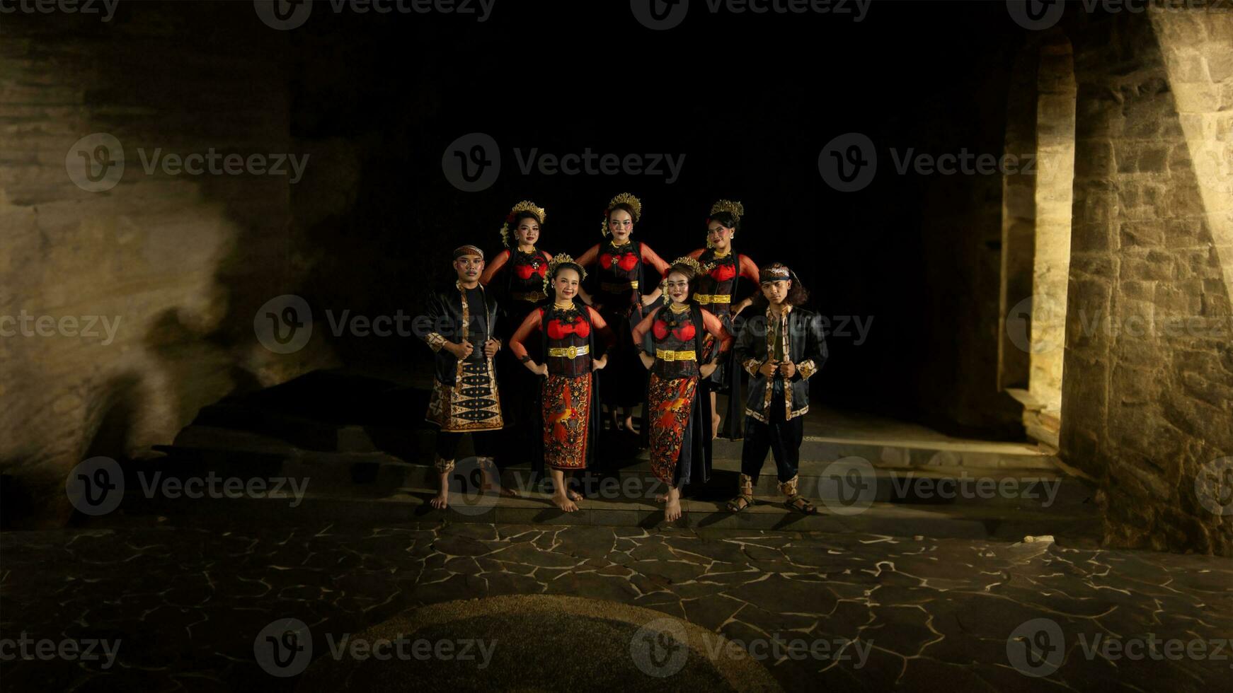 a group of dancers standing very proud and happy after finishing performing on stage photo