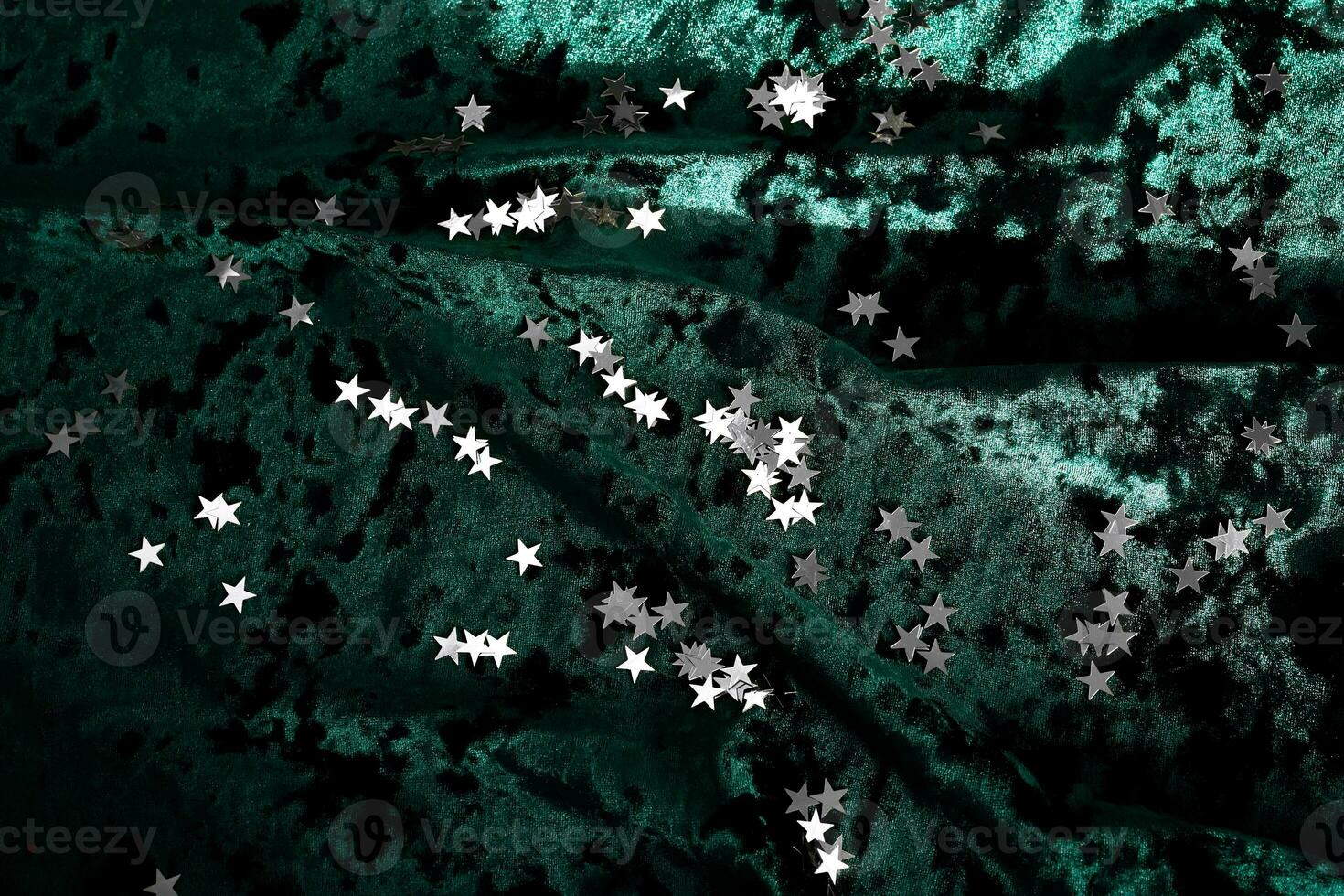 Abstract Christmas background with gold stars on a green velvet background. photo