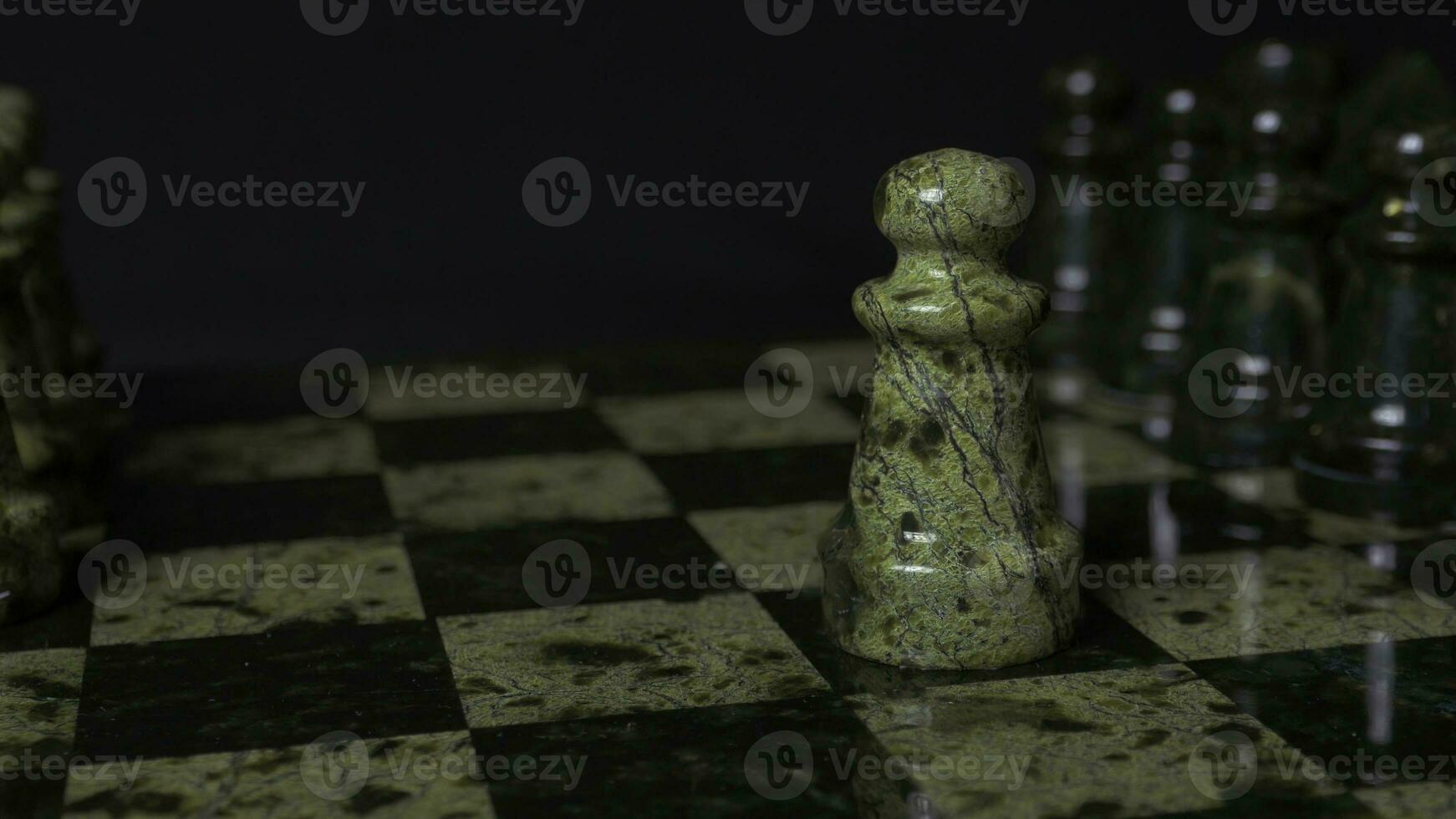 Chess game. White pawn defeats black pawn. Selective focus. Chess pawn defeated pawn. Details of chess piece on black background. photo