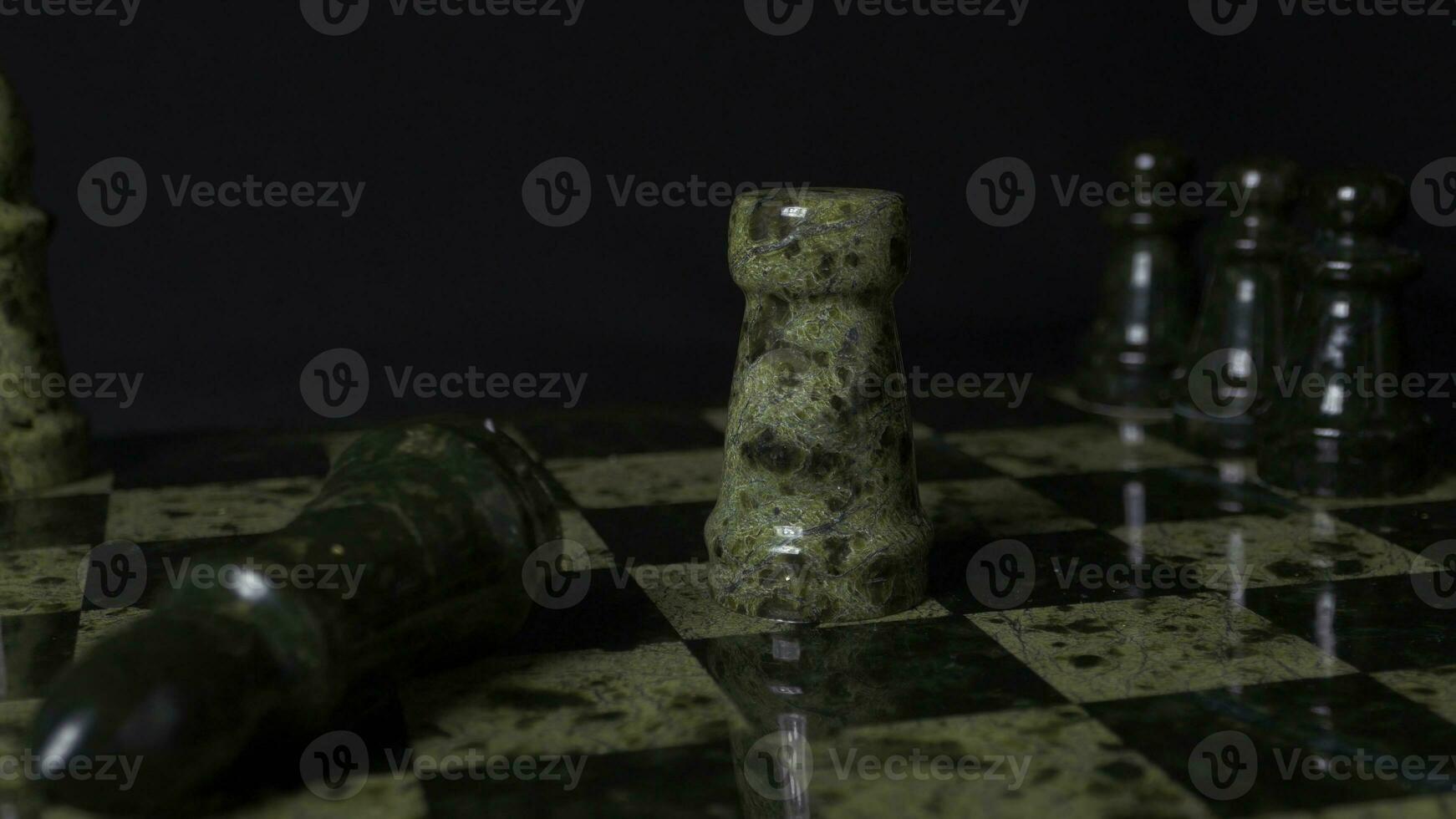 White Rook beats black Elephant on chessboard. Defeated chess Rook. Elephant holding woman's hand. Selective focus, close up view. Vintage toning. A rook in chess defeats elephant. photo