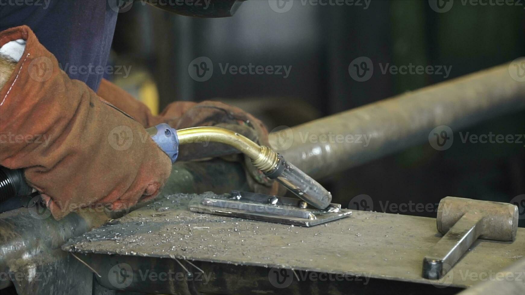 Industrial Worker at the refinery welding close up. Metal sawing close up. Clip. Close-up of welder working in workshop photo