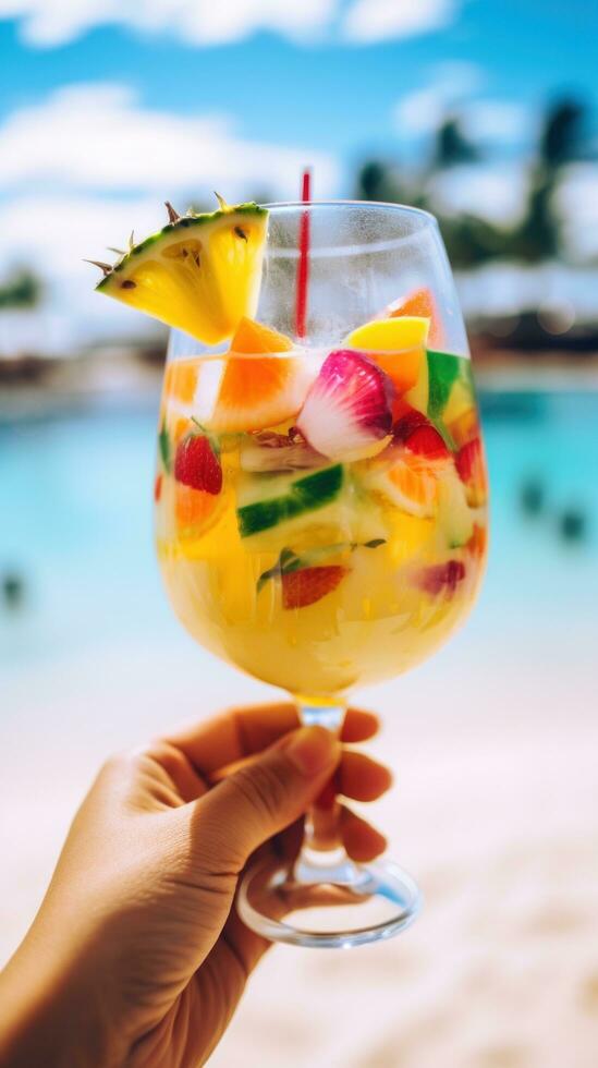 AI generated hand holding a colorful cocktail glass with a tropical beach background photo