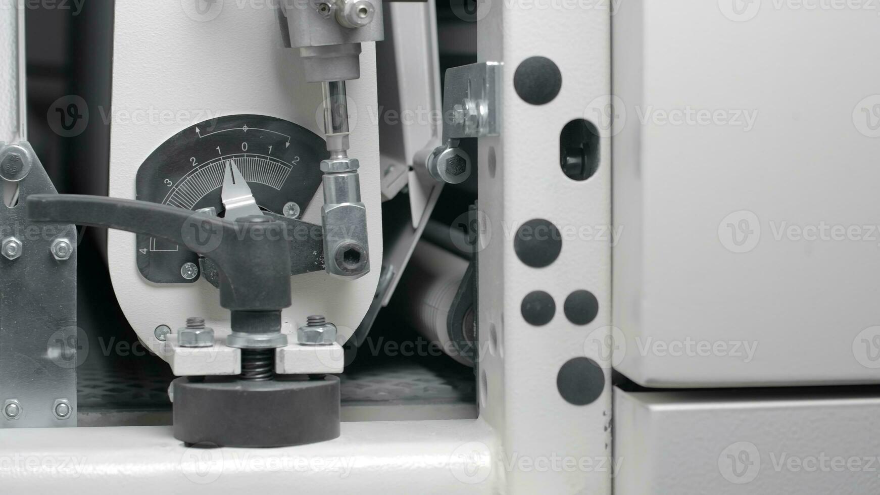 Close-up of conveyor machine with pressure indicator. Creative. Moving conveyor line with pressure. Production of rubber on conveyor machine photo