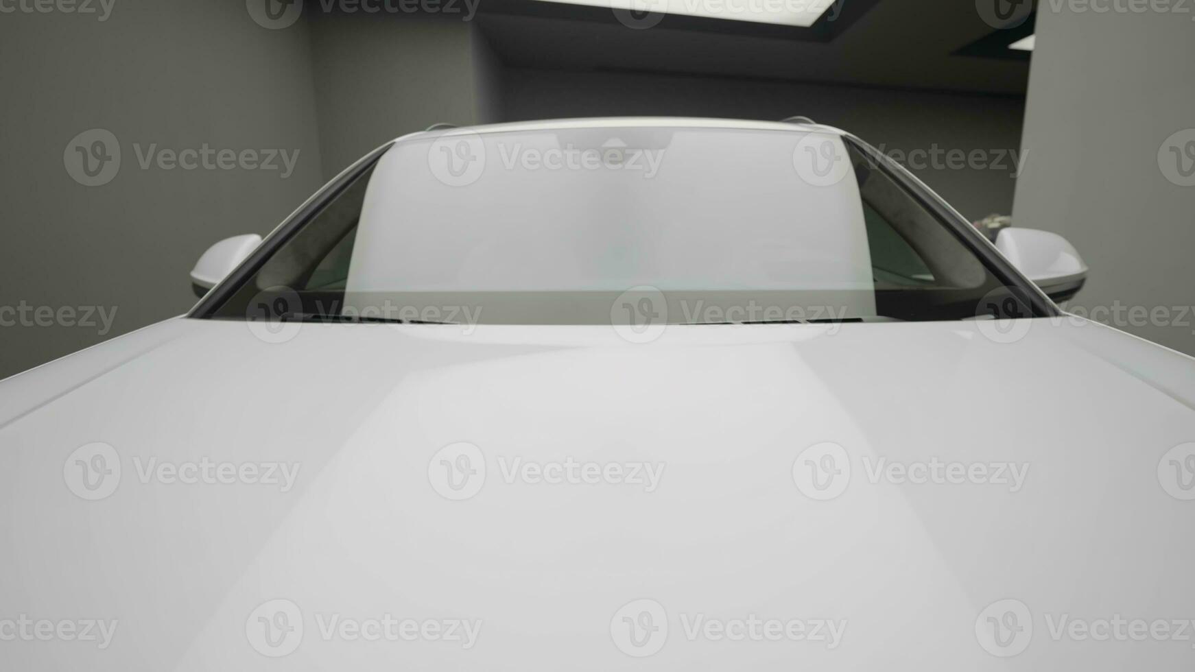 The white body of the car. Action. A bright car with a window and mirrors and a nice clean body standing in a nice place with light. photo