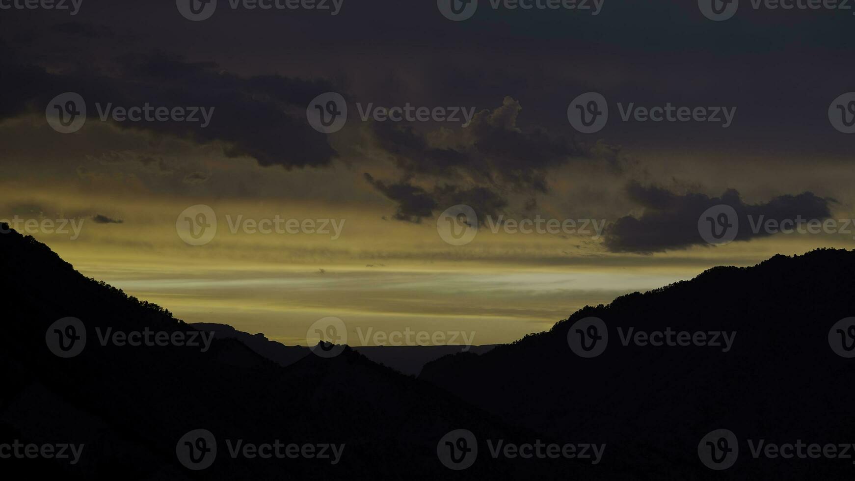 Dramatic sky during sunset above Alps, Switzerland. Action. Breathtaking natural background with the hills hidden in the shadow and beautiful sky. photo