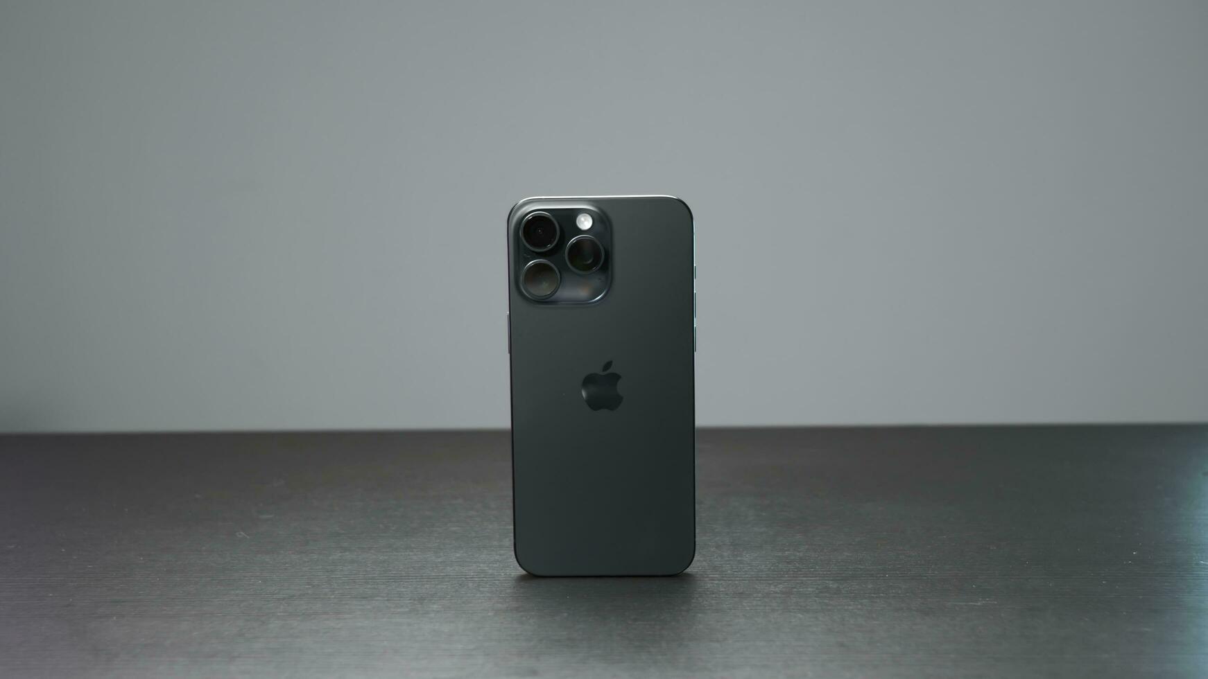 China, Beijing - September 15, 2023. New iPhone 15 pro. Action. New iPhone model from Apple with stylish design and additional technologies. Stylish iPhone model 15 pro max on gray background photo