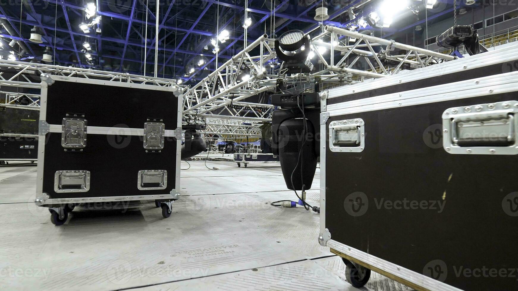 Installation of equipment and spotlights for stage. Stock footage. Preparing stage with bleachers and professional equipment and floodlights before performance or competition photo