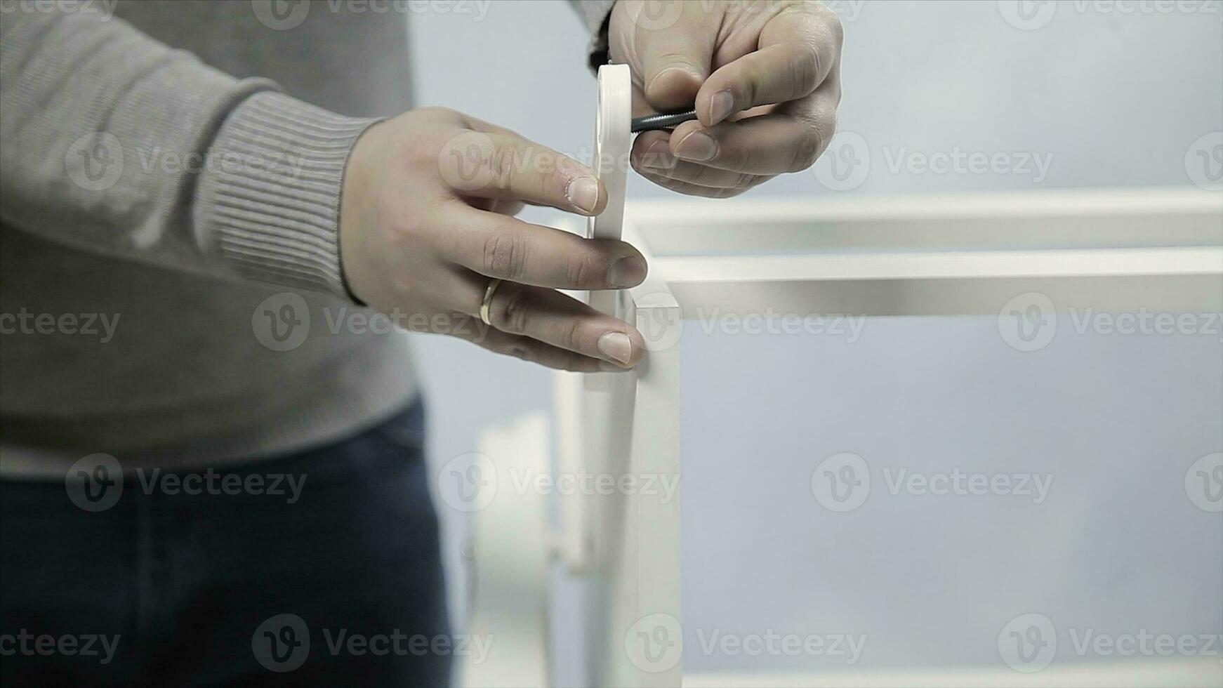 Man collects furniture in a workshop. Stock. Bonding and assembly of furniture on the wooden pins. photo