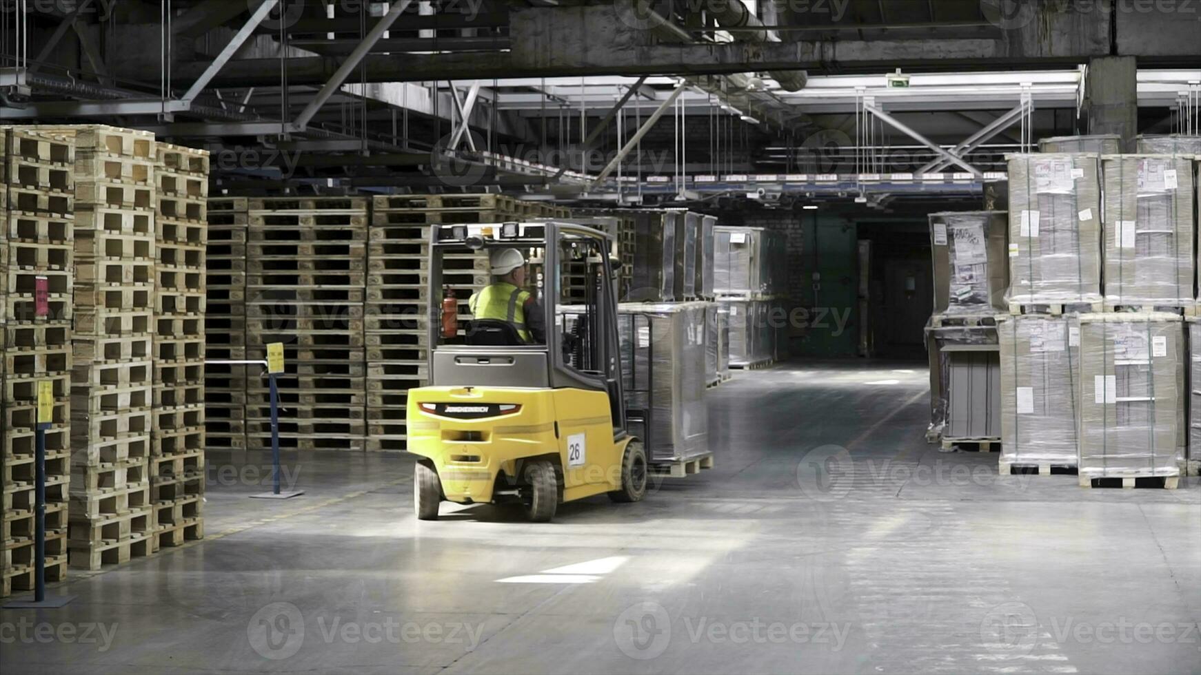 Fork lifter work in big warehouse. Clip. Warehouse man worker with forklift. Warehouse Rack of the Company photo