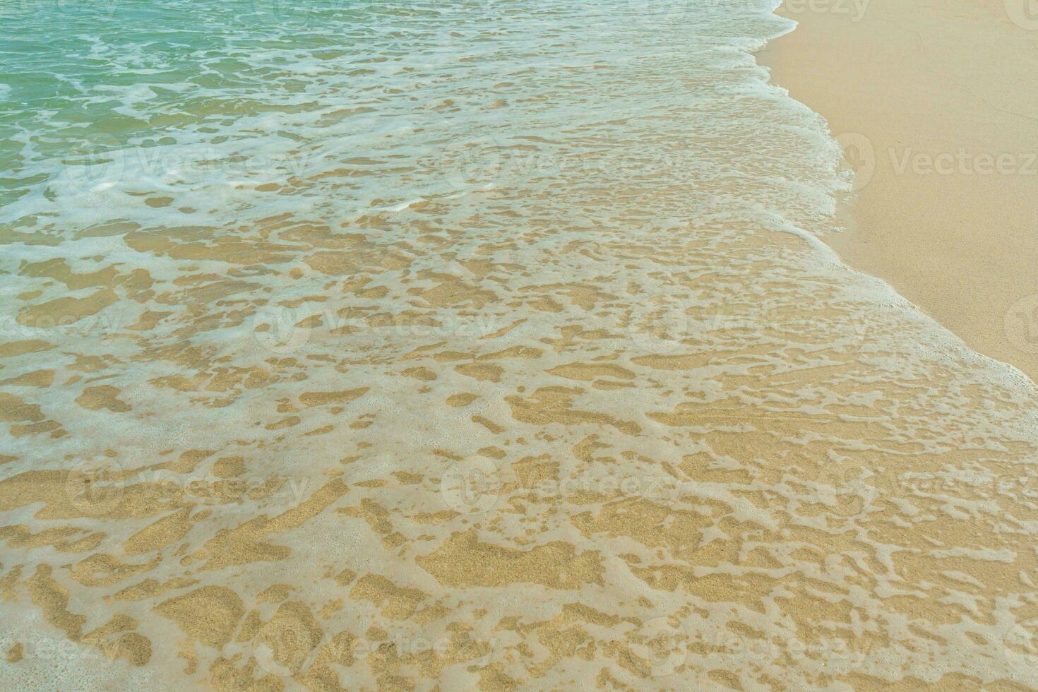 Soft wave of blue ocean on sandy beach. Summer vacation in island. clear azure water Background. photo