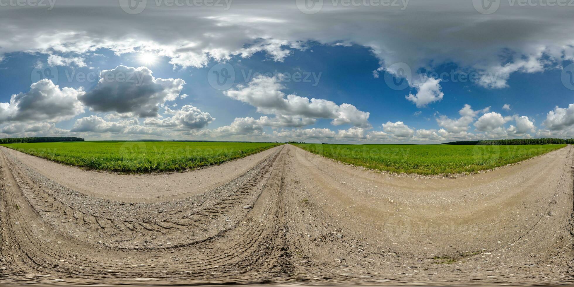 360 hdri panorama on gravel road with marks from car or tractor tires with clouds on blue sky in equirectangular spherical  seamless projection, skydome replacement in drone panoramas photo