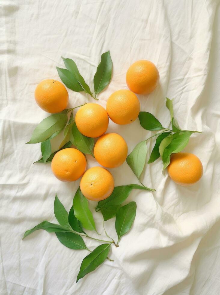 AI generated eight tangerines on white cloth, with green leaves, everyday ephemera, organic material photo