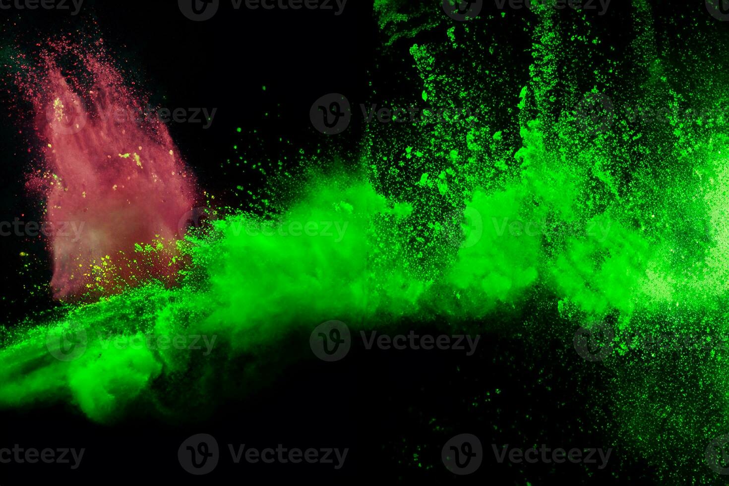 Green color powder explosion cloud on black background.Green dust splash. photo