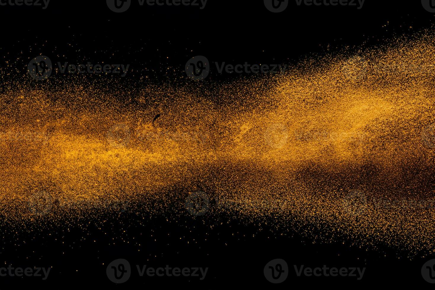 Abstract orange powder explosion isolated on black background. photo