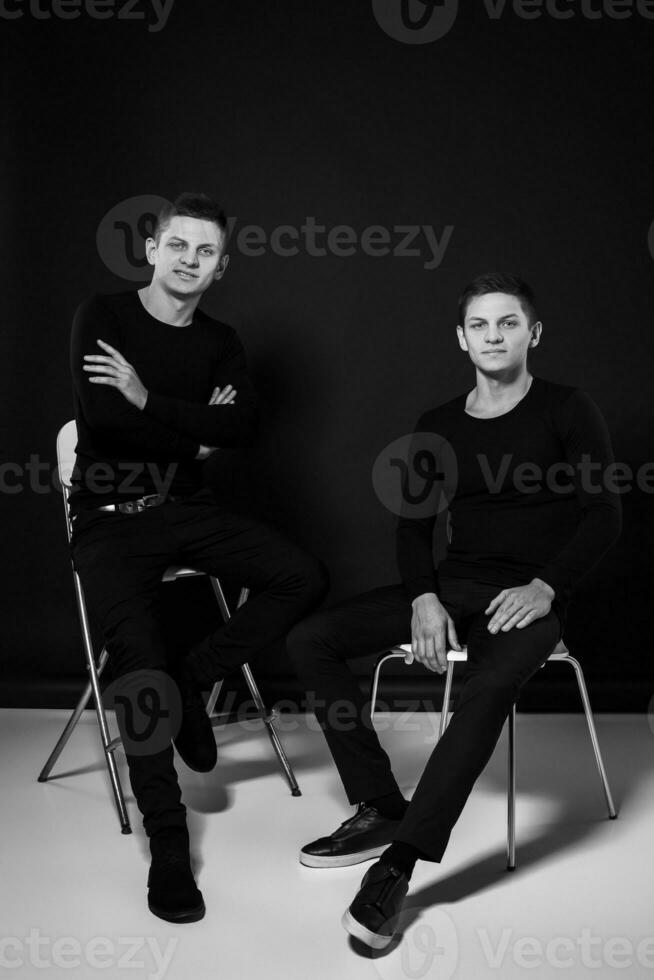 Casual twin brothers. Studio shot. Black and white photography photo