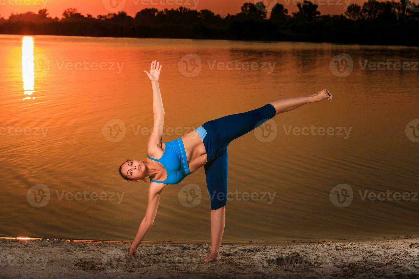 yoga at sunset on the beach. photo