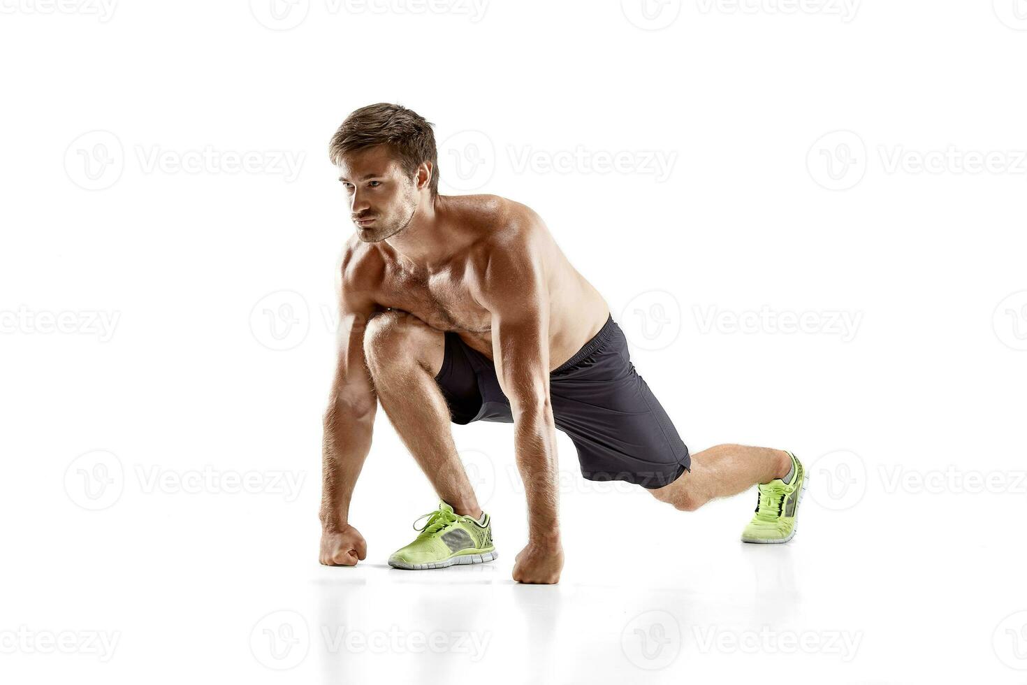 Sports young man doing push ups isolated on a white background photo