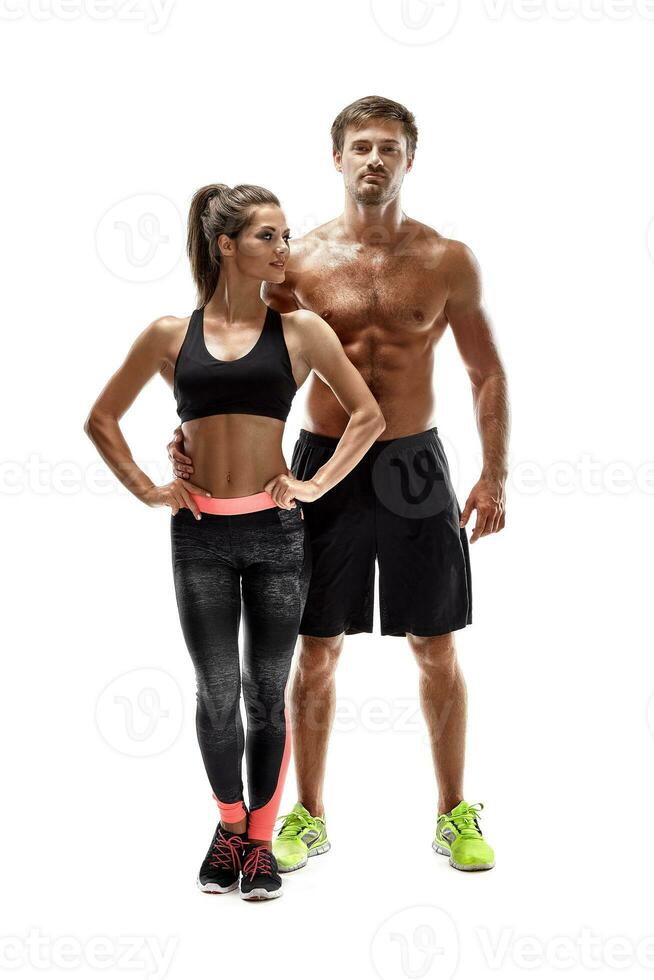 Young sportsmen couple woman and man in studio on white background photo