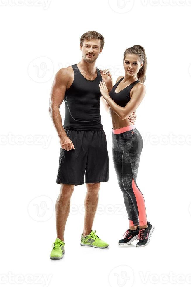Young sportsmen couple woman and man in studio on white background photo
