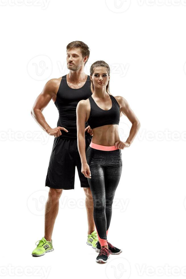 Sport, fitness, workout concept. Fit couple, strong muscular man and slim woman posing on a white background photo
