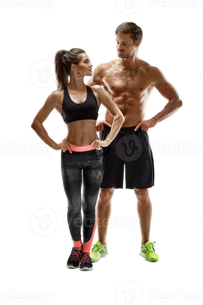 Sport, fitness, workout concept. Fit couple, strong muscular man and slim woman posing on a white background photo