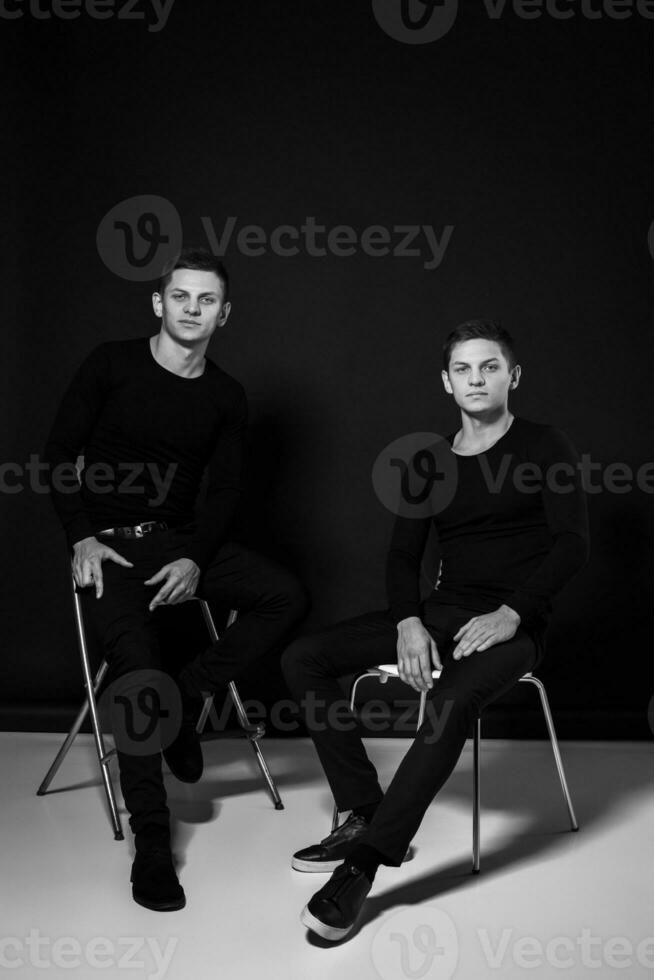 Casual twin brothers. Studio shot. Black and white photography photo