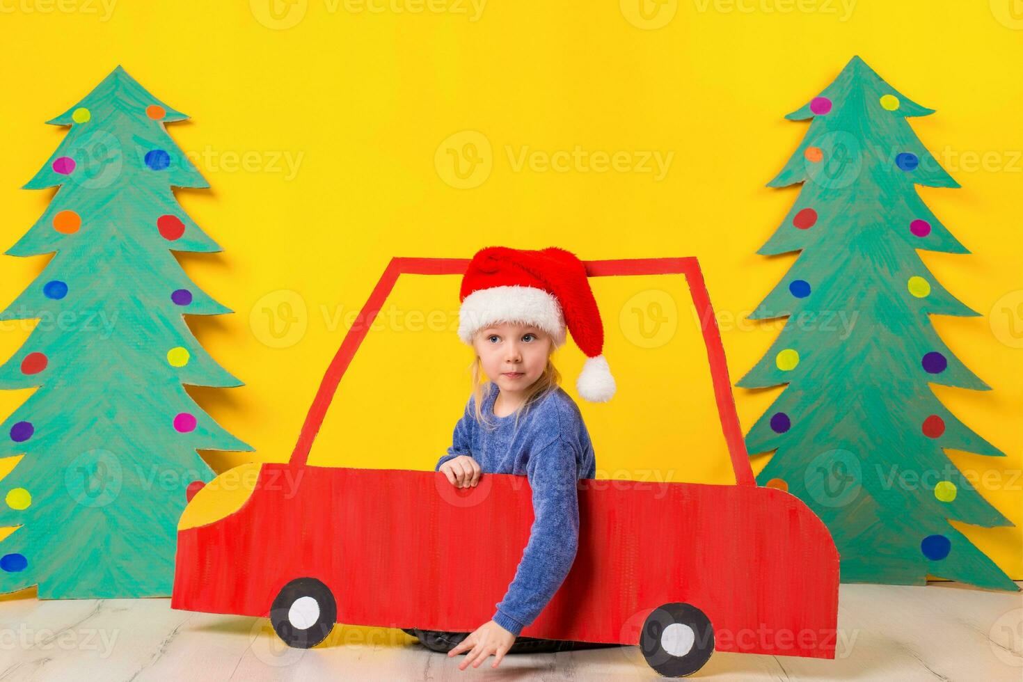 Child in red Christmas car. Xmas holiday concept photo