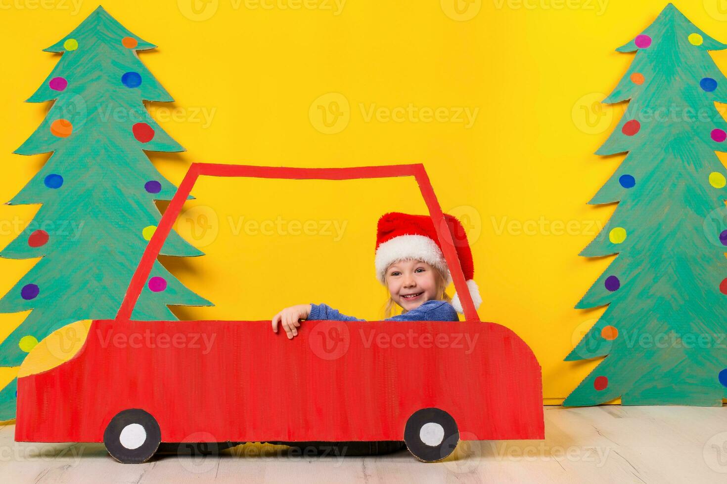 Child in red Christmas car. Xmas holiday concept photo