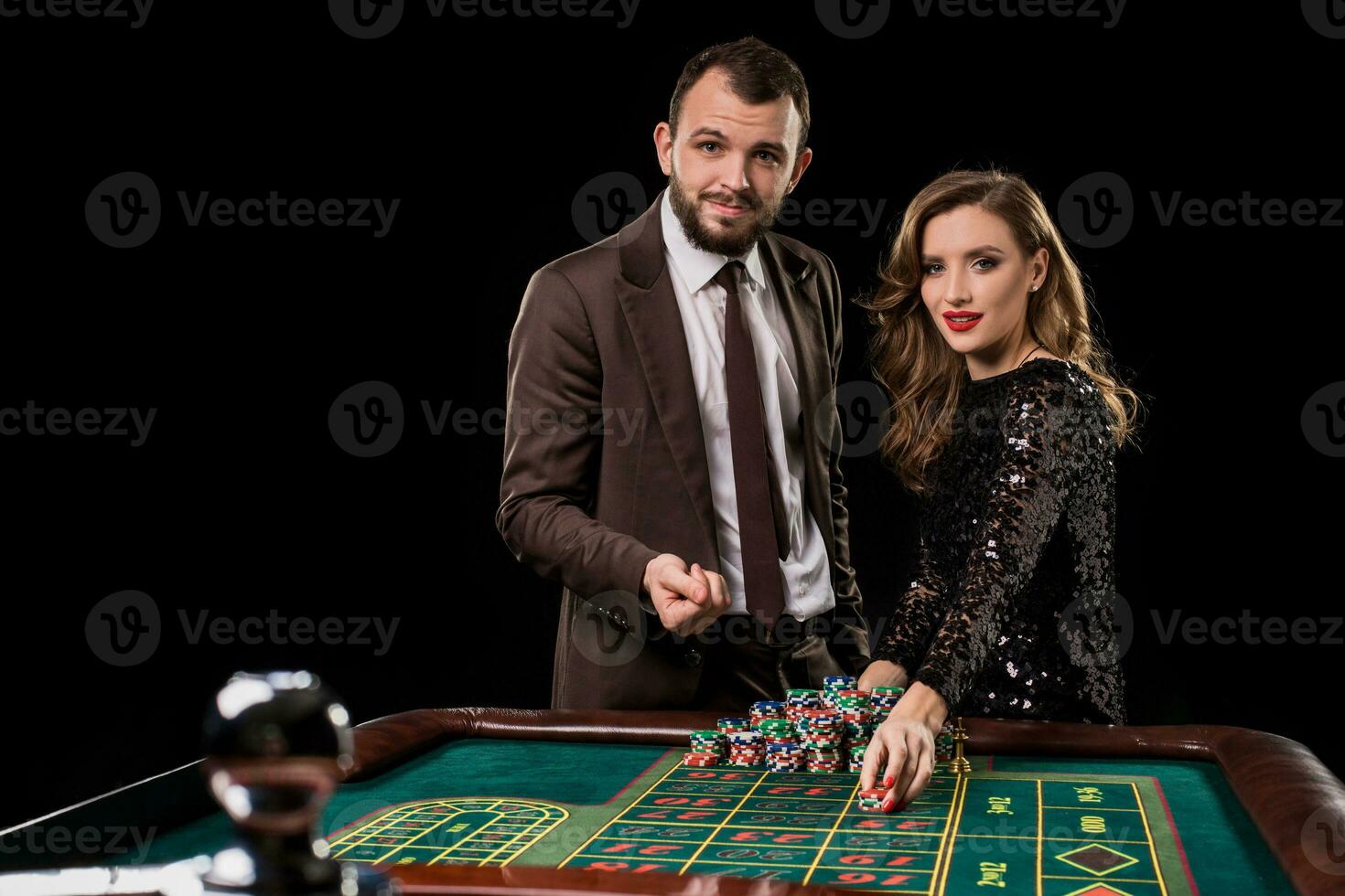 hombre y mujer jugando a ruleta mesa en casino foto