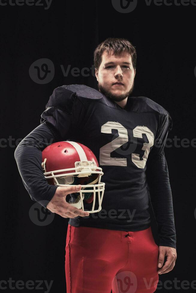 Football player on dark background photo