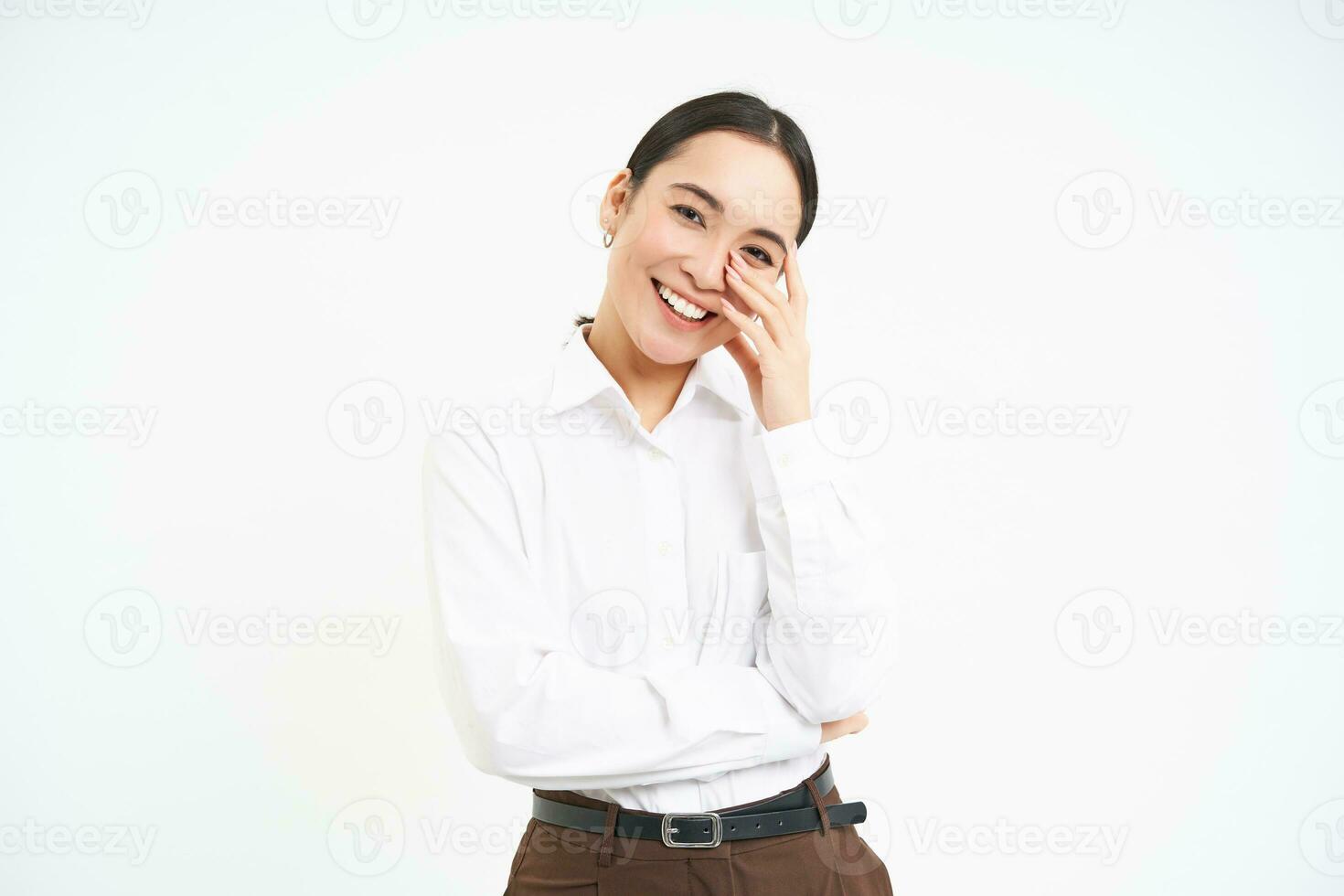 Wellbeing and workplace. Smiling happy asian saleswoman, office manager laughing and looking joyful, isolated over white background photo
