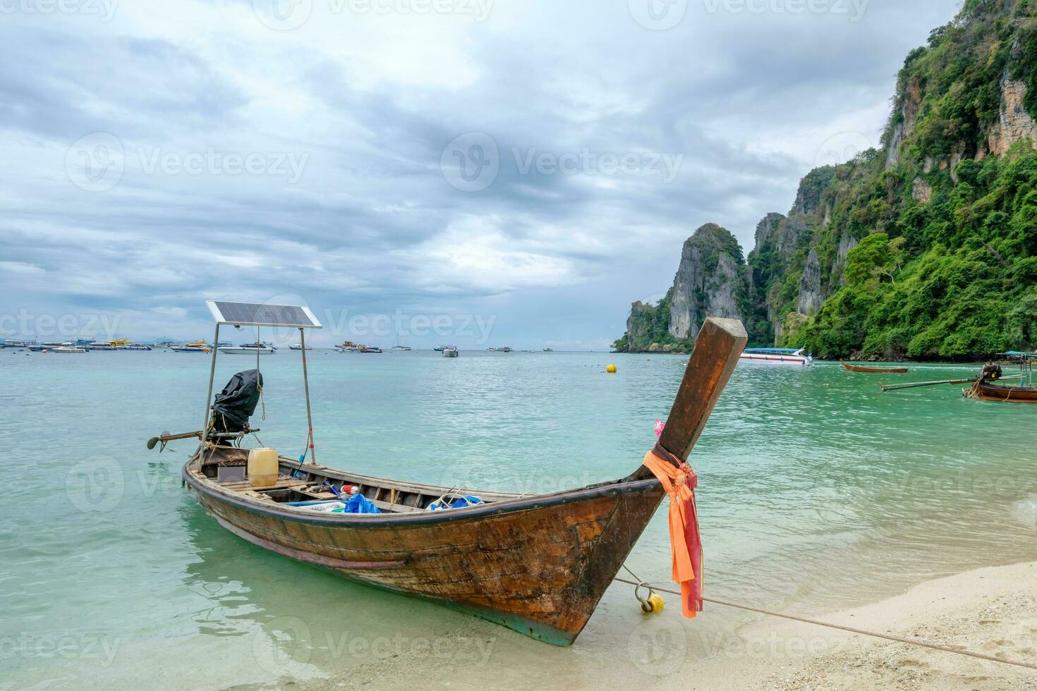 Wooden long tail boat anchored on phi phi island photo