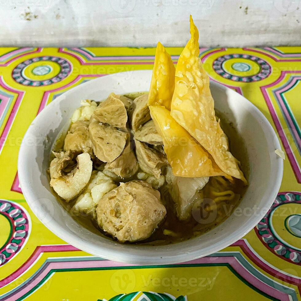 bakso or baso, traditional Indonesian food, with meatballs and noodles served in beef broth photo