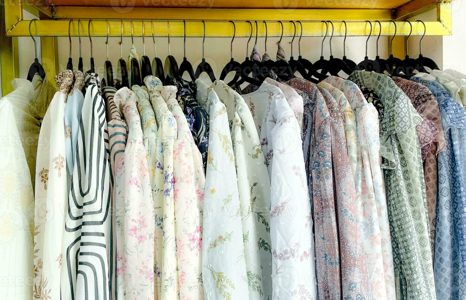 Close-up of color shirts hanging on the rack in fashion store photo