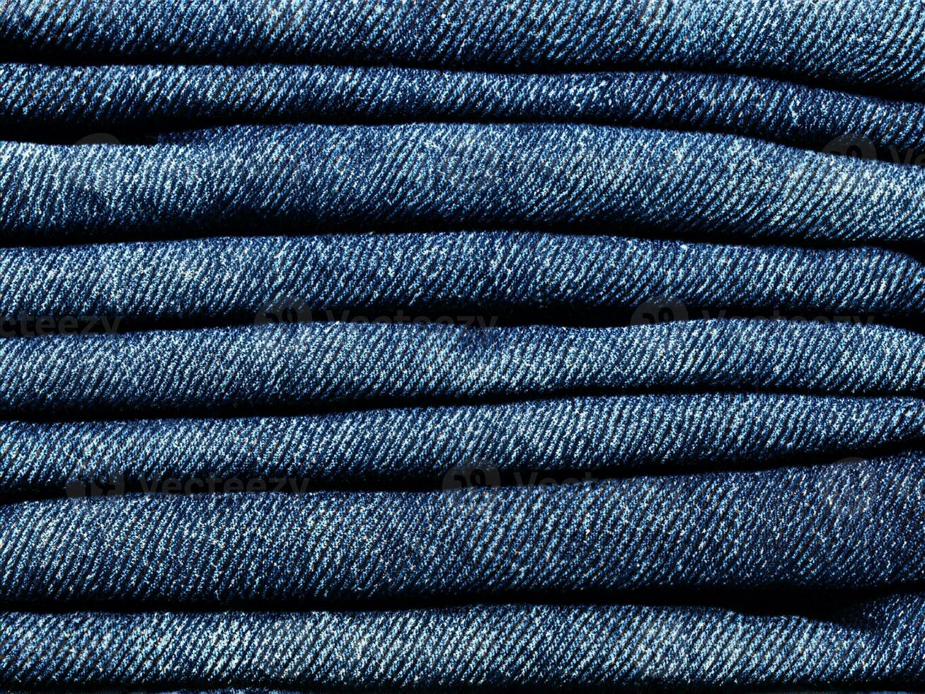 stack of blue jeans background photo