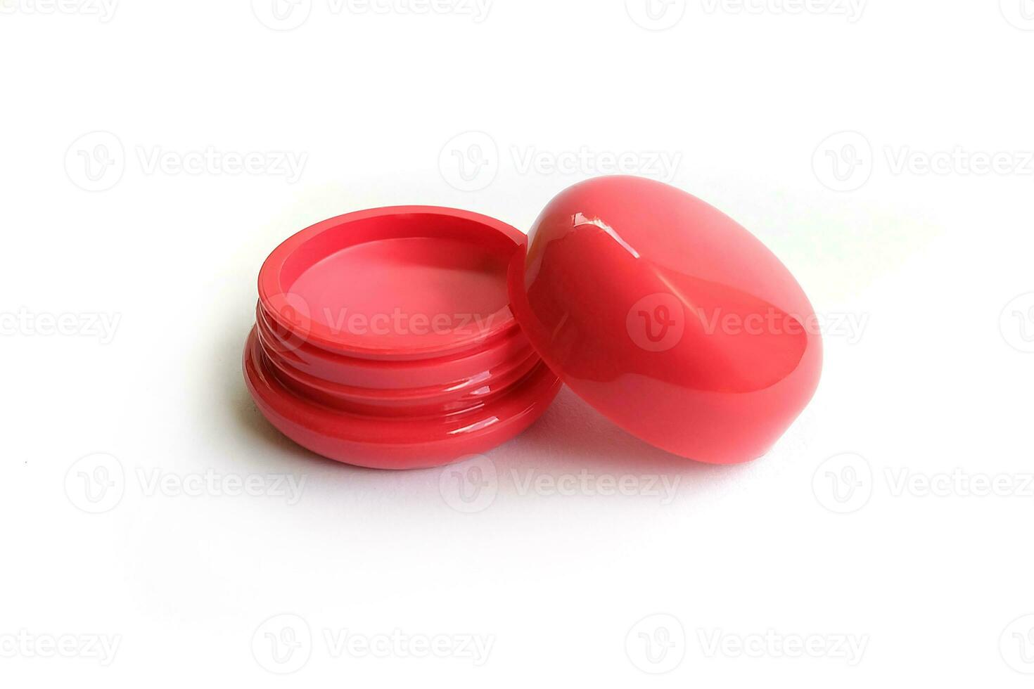 Red lipstick in a glossy round case on a white background. photo