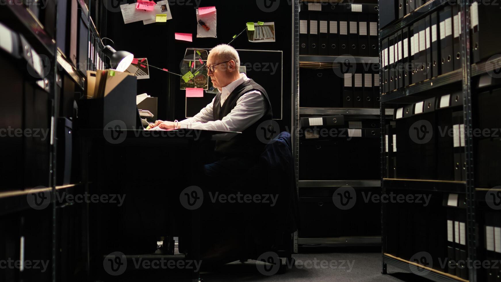 Private detective reading files, checking forensic evidence reports on classified documents in incident room. Law officer undertaking investigatory services with witness statements, uncover clues. photo