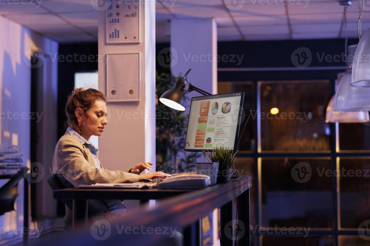 Executive manager working overhours at financial project, analyzing growth report on computer. Businesswoman planning company strategy, developing investment plan to increase profit. Business concept photo
