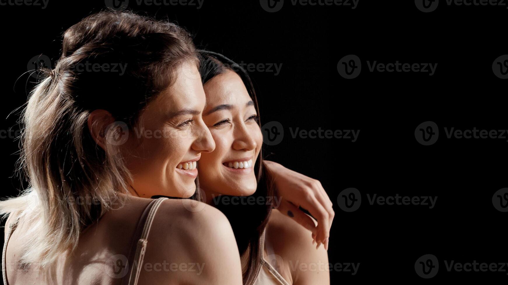 Smiling women with different skintones and body types posing in skincare campaign, promoting body positivity, self confidence and self love. Interracial friends laughing and having fun. photo
