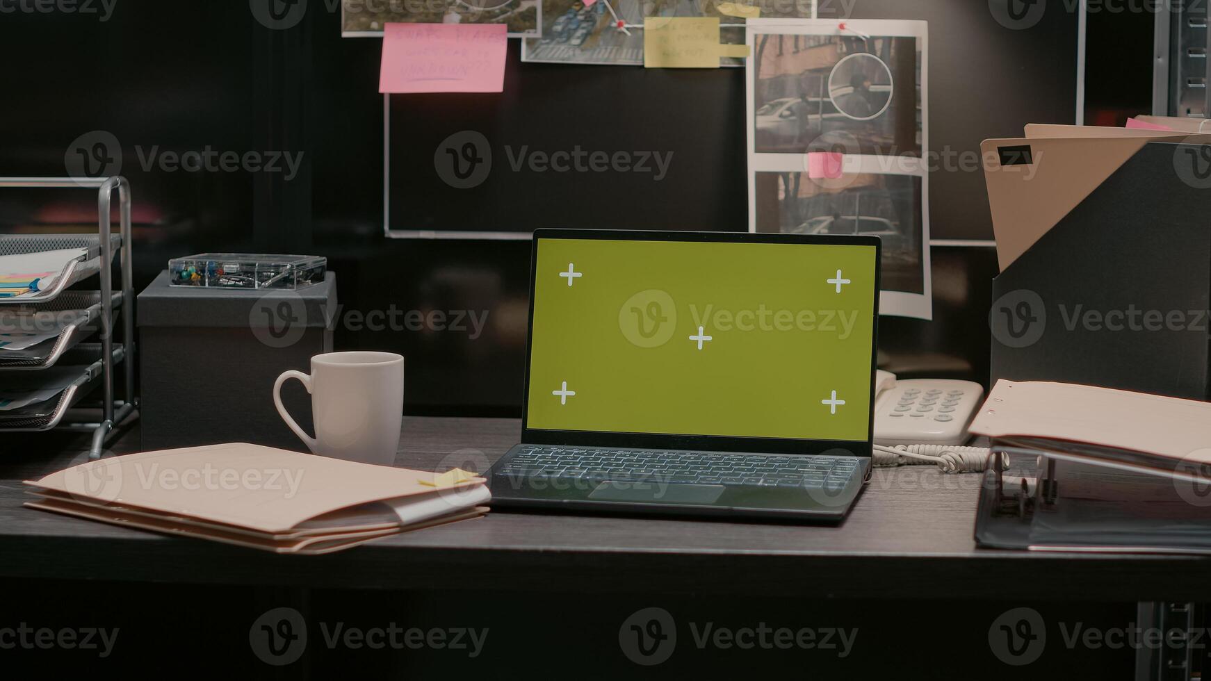 Modern laptop with greenscreen placed on archive desk in police evidence room, blank mockup template on pc. Wireless computer showing isolated chroma key copyspace, incident room. photo