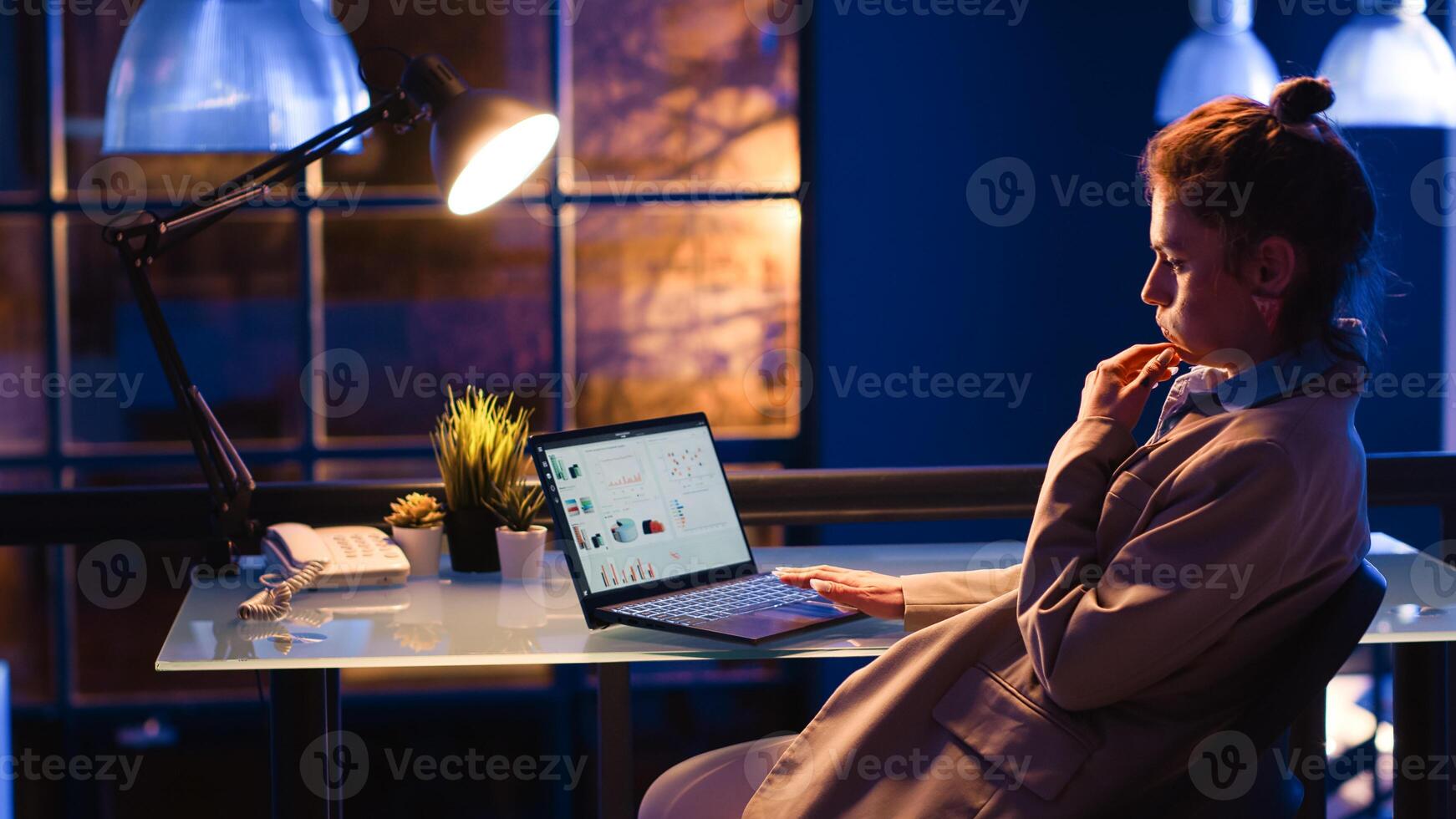 Female worker planning financial statistics in business space, working on company growth report. Young employee using analytics graphs on computer, corporate investment management plan. photo