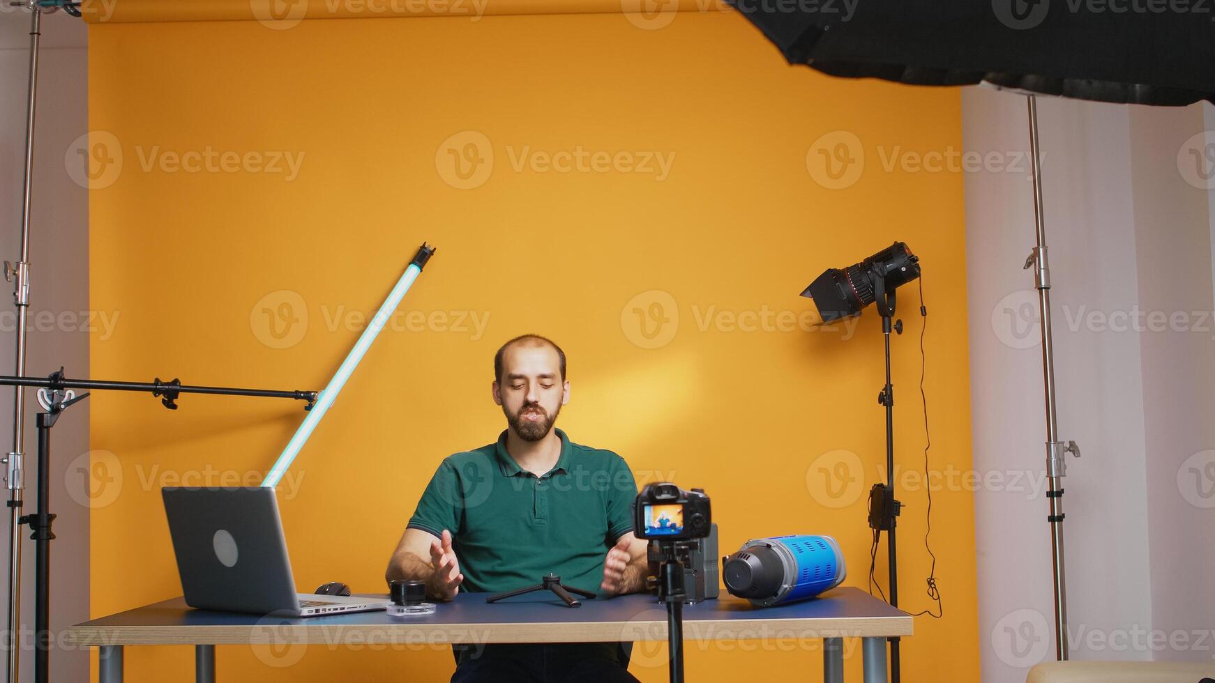 Vlogger recording testimonial about mini trepied for subscribers. Professional studio video and photo equipment technology for work, photo studio social media star and influencer